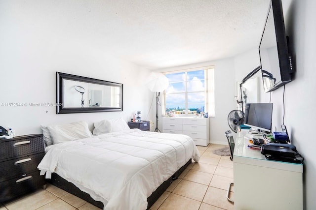 tiled bedroom with a textured ceiling