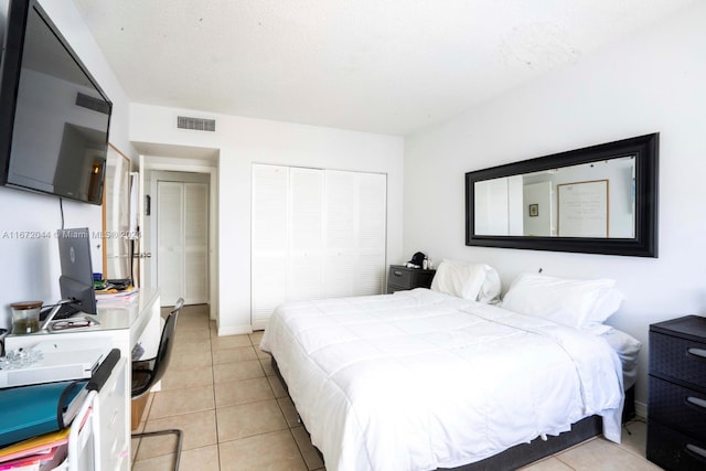 bedroom featuring a closet and light tile patterned floors