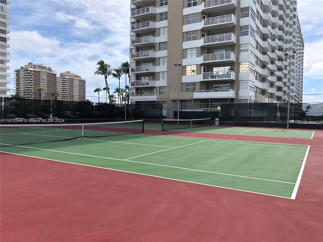 view of tennis court featuring basketball hoop