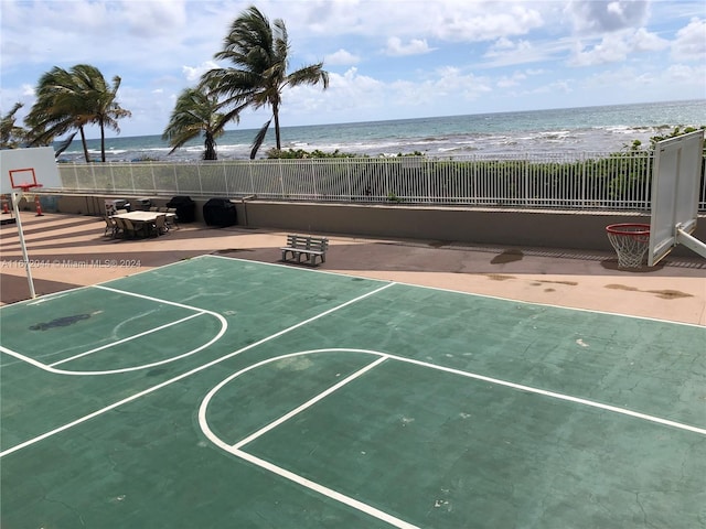 view of basketball court with a view of the beach and a water view