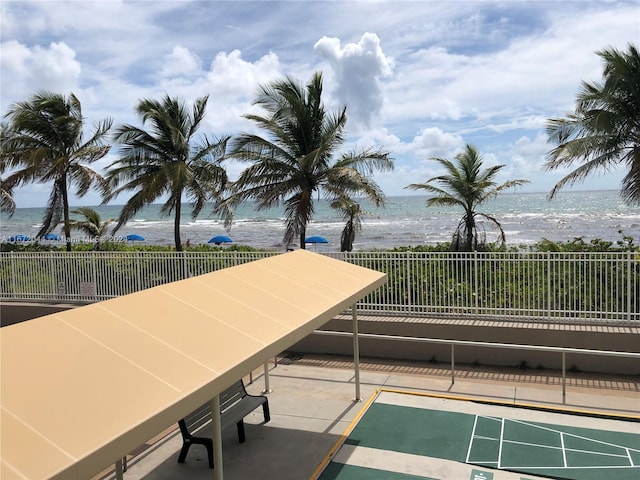 view of home's community featuring a water view and a beach view