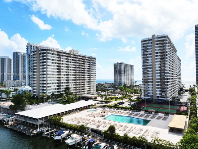 view of pool featuring a water view and a patio area