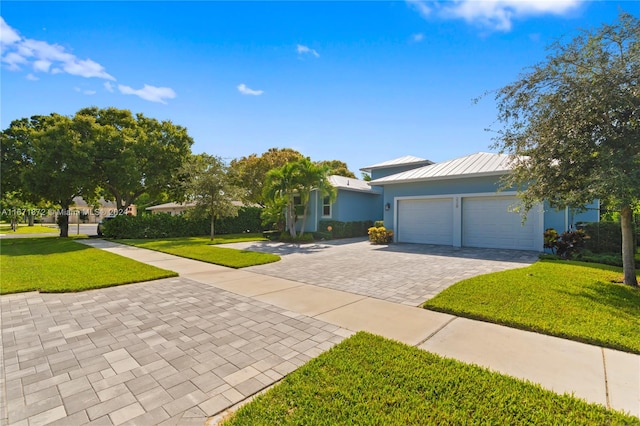 view of front of property featuring a garage and a front yard