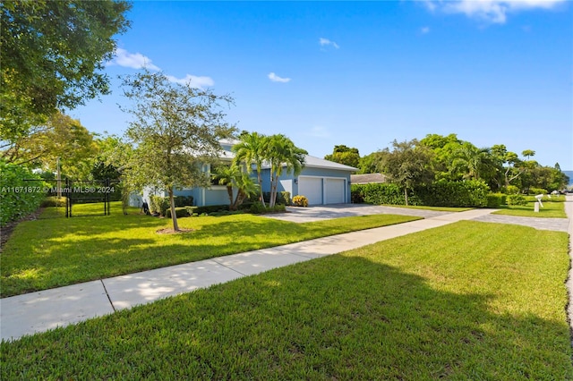 view of front of home featuring a garage and a front lawn