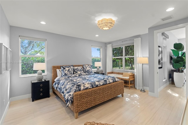 bedroom featuring multiple windows and light wood-type flooring