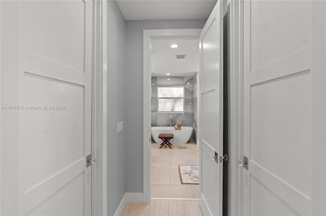 hall featuring light tile patterned flooring