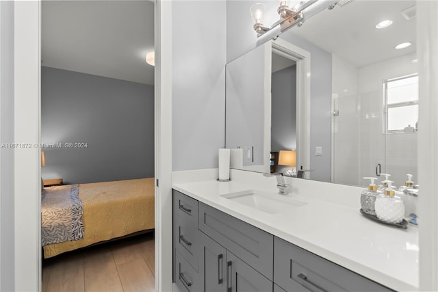 bathroom featuring vanity, an enclosed shower, and hardwood / wood-style floors