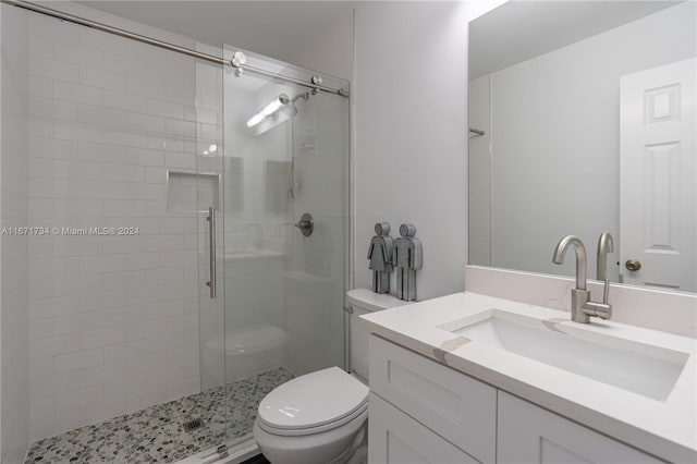 bathroom featuring walk in shower, vanity, and toilet