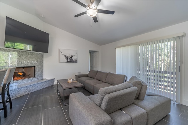 living room with ceiling fan, a high end fireplace, and lofted ceiling