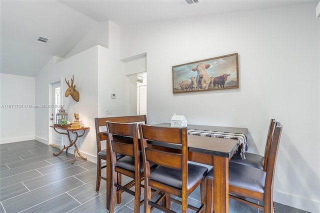 dining space featuring vaulted ceiling