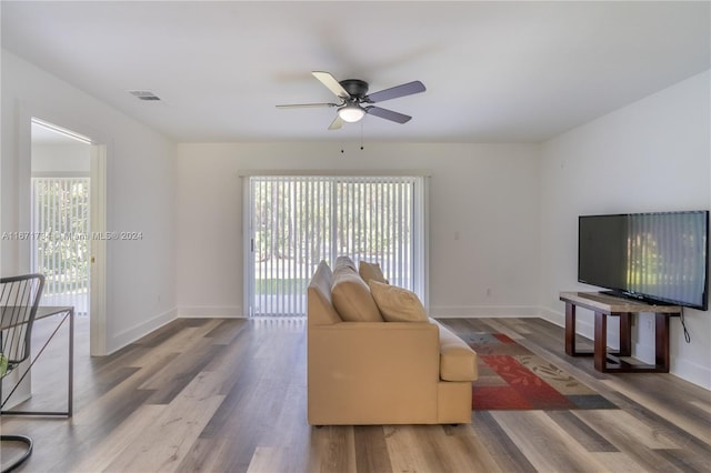 living room featuring hardwood / wood-style floors and ceiling fan