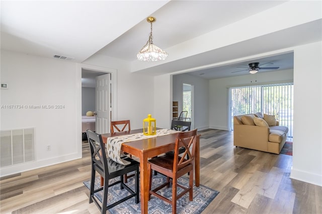 dining space with light hardwood / wood-style flooring and ceiling fan