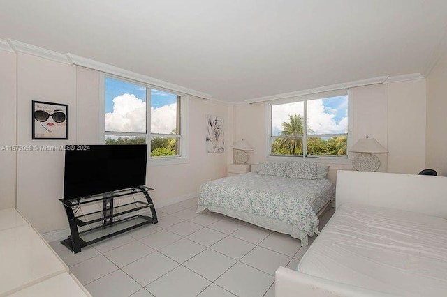 bedroom featuring crown molding, light tile patterned floors, and multiple windows