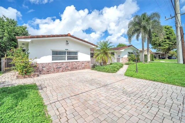 mediterranean / spanish-style home featuring a front lawn