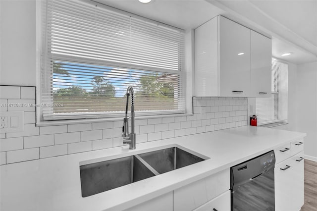 2827 Arthur St, Hollywood, FL 33020 - kitchen featuring dishwasher, white cabinetry, light countertops, and decorative backsplash