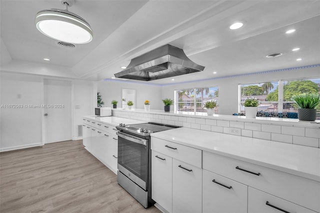 2827 Arthur St, Hollywood, FL 33020 - kitchen with electric range, exhaust hood, a raised ceiling, light wood-type flooring, and light countertops