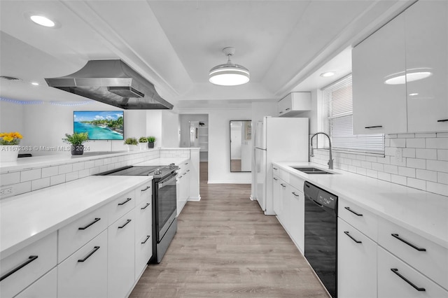 2827 Arthur St, Hollywood, FL 33020 - kitchen with stainless steel electric range, black dishwasher, wall chimney exhaust hood, freestanding refrigerator, and tasteful backsplash