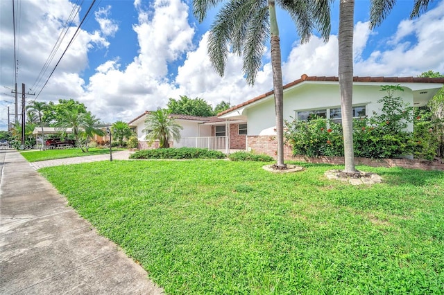 2827 Arthur St, Hollywood, FL 33020 - view of front of property with stucco siding, a front yard, and driveway