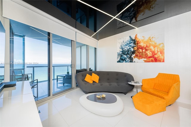 sitting room featuring tile patterned flooring and a water view