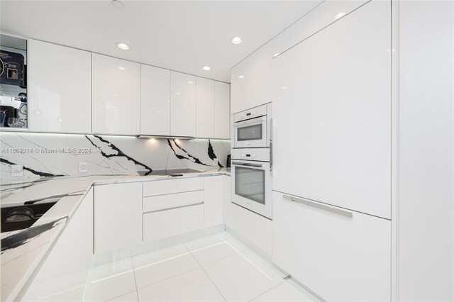 17121 Collins Ave Unit 1103, Sunny Isles Beach, FL 33160 - kitchen featuring oven, modern cabinets, white cabinets, tasteful backsplash, and recessed lighting