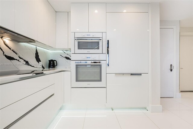 17121 Collins Ave Unit 1103, Sunny Isles Beach, FL 33160 - kitchen with modern cabinets, white cabinetry, white appliances, and light countertops