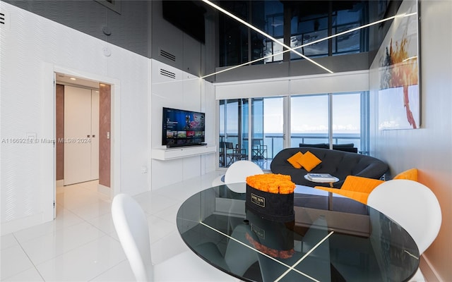 tiled living room with a towering ceiling