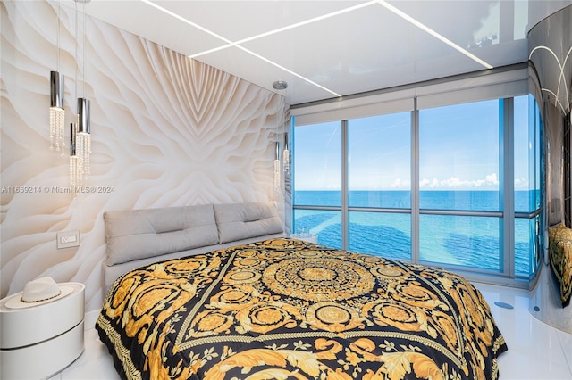 bedroom featuring tile patterned flooring and a water view