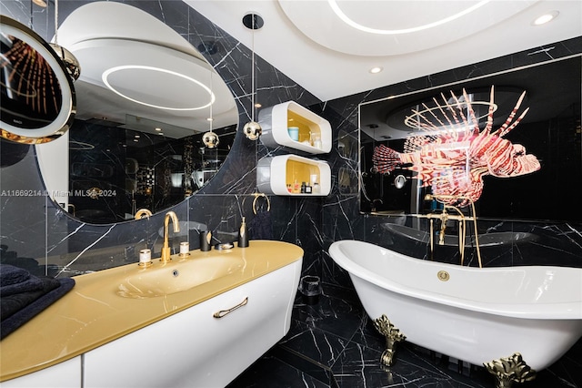 bathroom with tile walls, decorative backsplash, a tub, and vanity