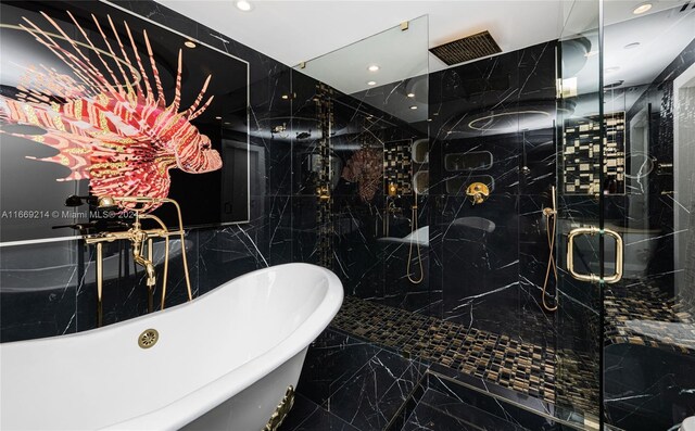 17121 Collins Ave Unit 1103, Sunny Isles Beach, FL 33160 - bathroom with tile walls, marble tiled floors, a soaking tub, a marble finish shower, and recessed lighting