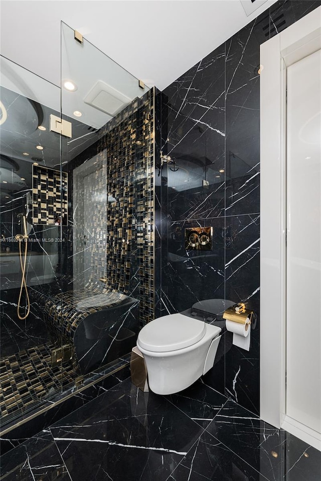 bathroom with tile walls, toilet, and tiled shower