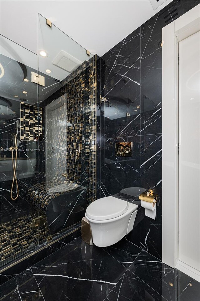 17121 Collins Ave Unit 1103, Sunny Isles Beach, FL 33160 - bathroom featuring tile walls, toilet, a marble finish shower, marble tiled flooring, and recessed lighting