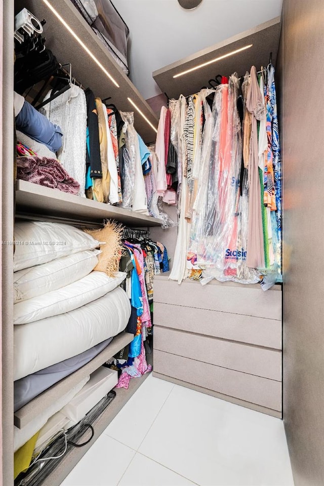 walk in closet with light tile patterned floors