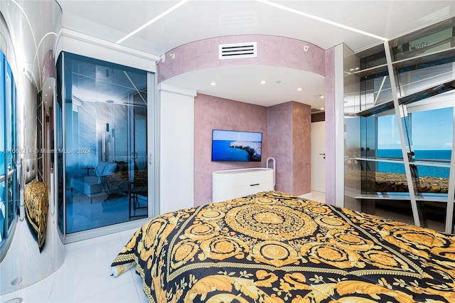 bedroom featuring a water view and tile patterned floors