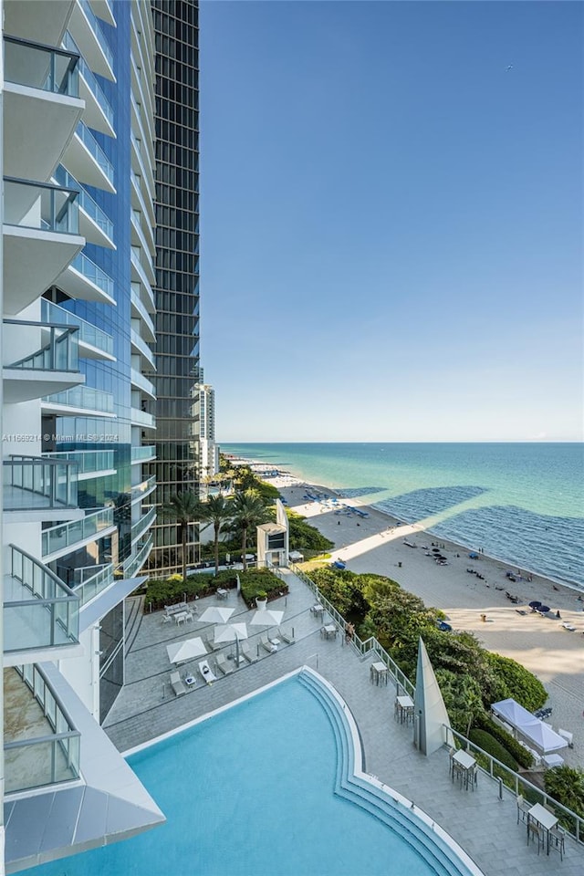 view of swimming pool featuring a beach view and a water view