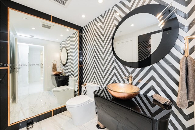 17121 Collins Ave Unit 1103, Sunny Isles Beach, FL 33160 - bathroom with wallpapered walls, marble tiled floors, toilet, recessed lighting, and vanity