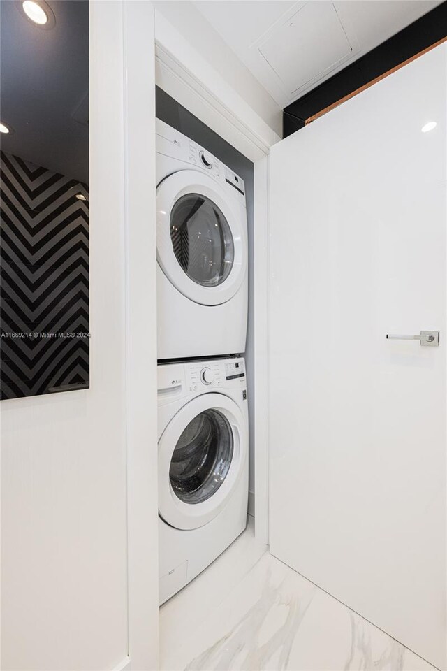 17121 Collins Ave Unit 1103, Sunny Isles Beach, FL 33160 - washroom featuring stacked washer / dryer, marble finish flooring, and recessed lighting