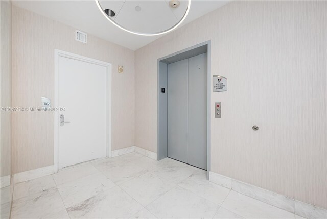 17121 Collins Ave Unit 1103, Sunny Isles Beach, FL 33160 - empty room featuring elevator and light marble finish flooring