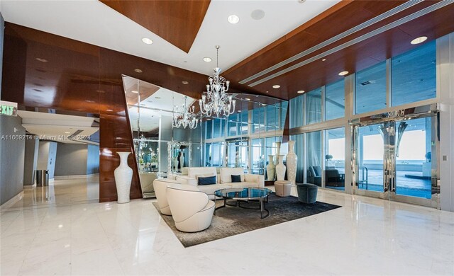 17121 Collins Ave Unit 1103, Sunny Isles Beach, FL 33160 - building lobby featuring a towering ceiling, recessed lighting, and floor to ceiling windows