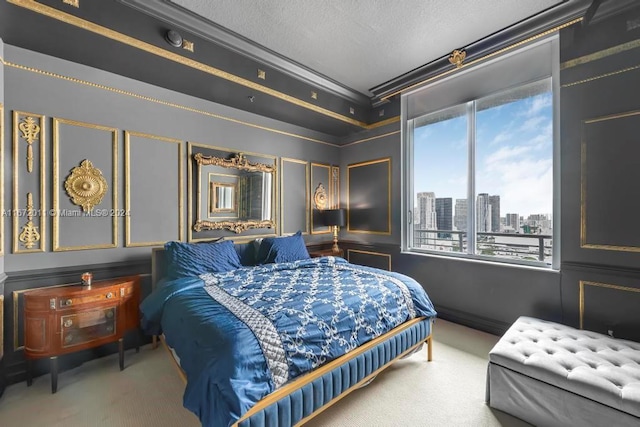 carpeted bedroom with a textured ceiling and crown molding