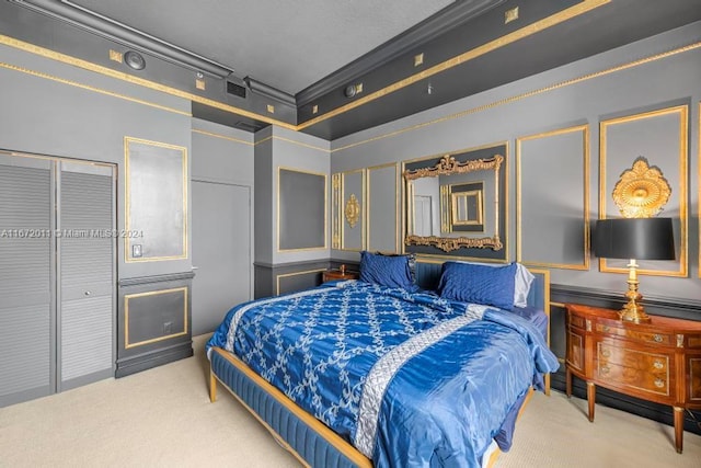 bedroom with carpet flooring, ornamental molding, and a closet