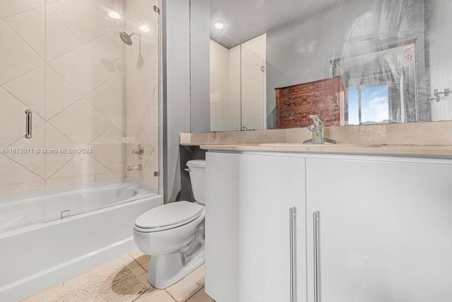 full bathroom featuring tile patterned flooring, shower / bath combination with glass door, vanity, and toilet