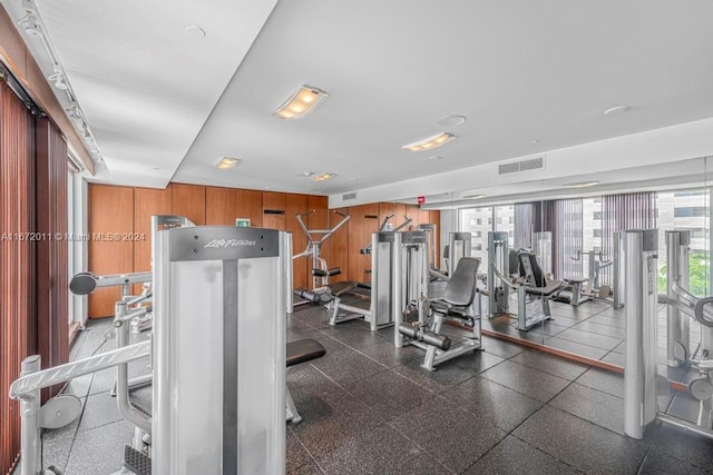 exercise room with wood walls