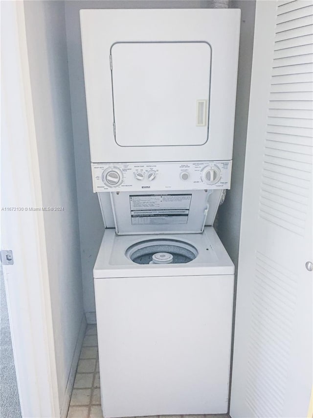 laundry area with stacked washing maching and dryer