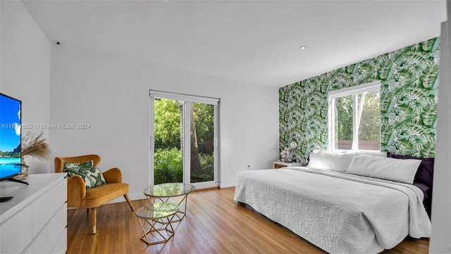 bedroom featuring light hardwood / wood-style floors and multiple windows