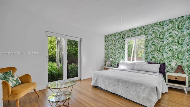 bedroom featuring light hardwood / wood-style floors and multiple windows