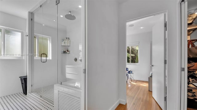 bathroom featuring walk in shower and hardwood / wood-style floors