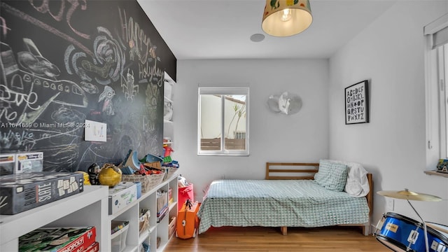 bedroom with hardwood / wood-style flooring