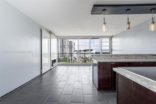 kitchen with pendant lighting, a textured ceiling, and floor to ceiling windows