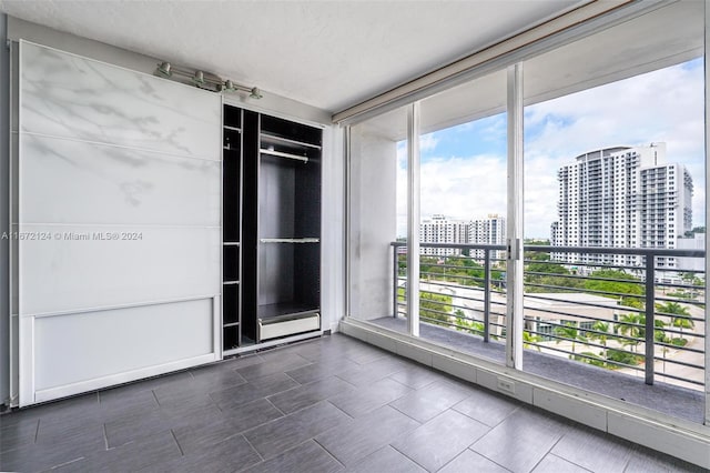 spare room with expansive windows and plenty of natural light