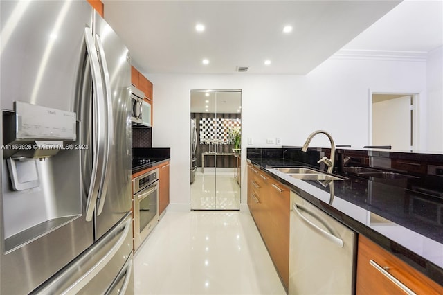 kitchen featuring light tile patterned floors, ornamental molding, tasteful backsplash, stainless steel appliances, and dark stone counters